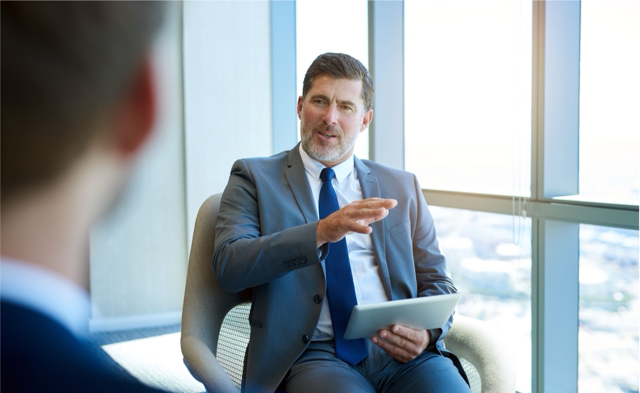 A leader in conversation, talking and gesturing